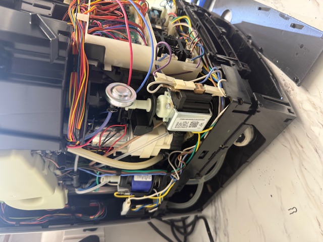 Jura coffee machine internal components being cleaned during expert service and repair process