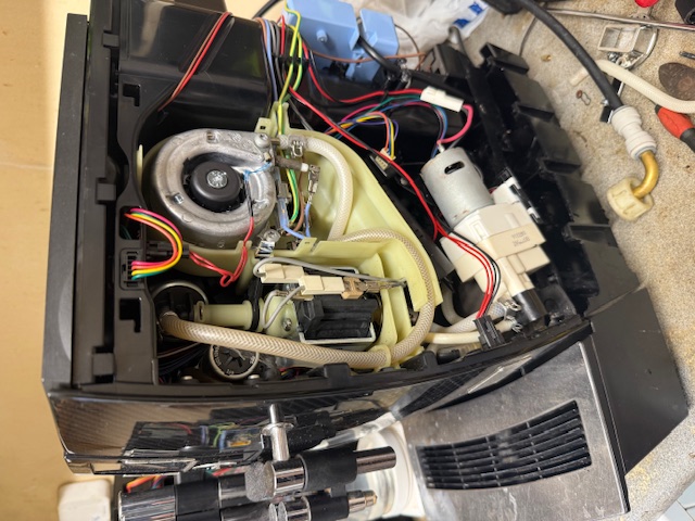 Professional Jura service engineer replacing genuine parts during coffee machine maintenance in Devon